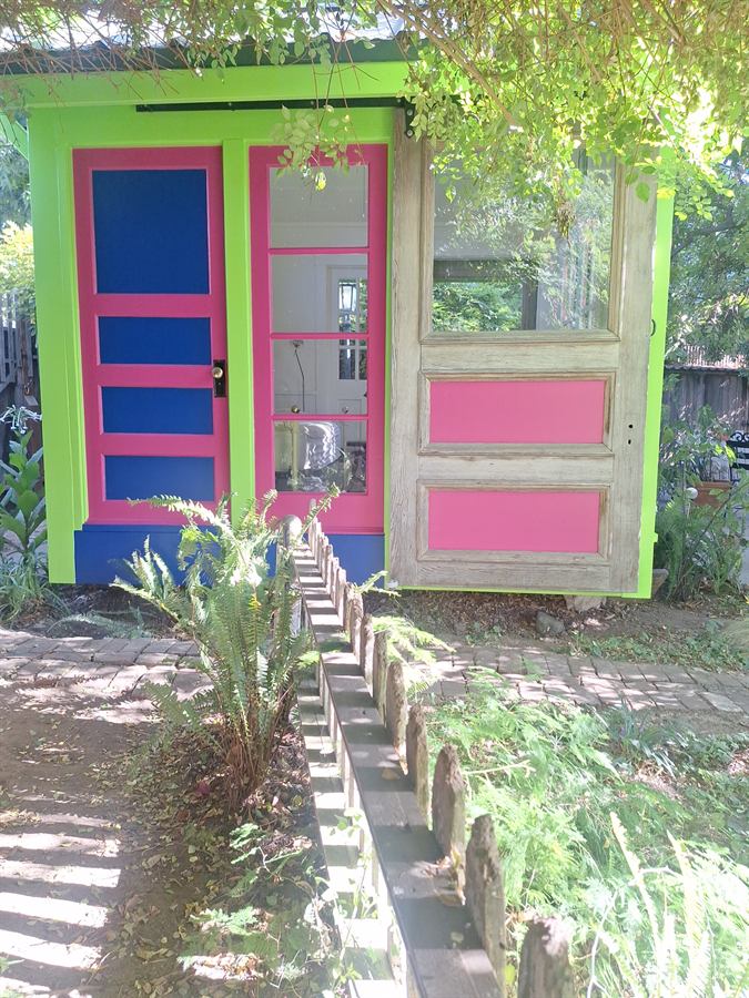 Repainted cottage frontage seen across the garden path